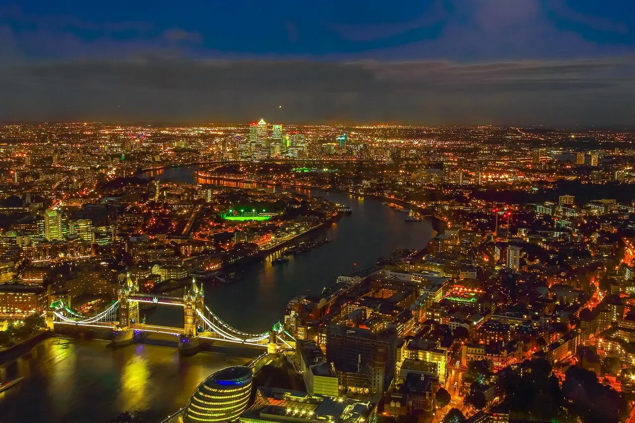 London skyline at night with Tower Bridge and River Thames illuminated
