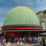 Madame Tussauds London entrance building with green dome and visitors queueing outside