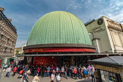 Madame Tussauds London entrance building with green dome and visitors queueing outside