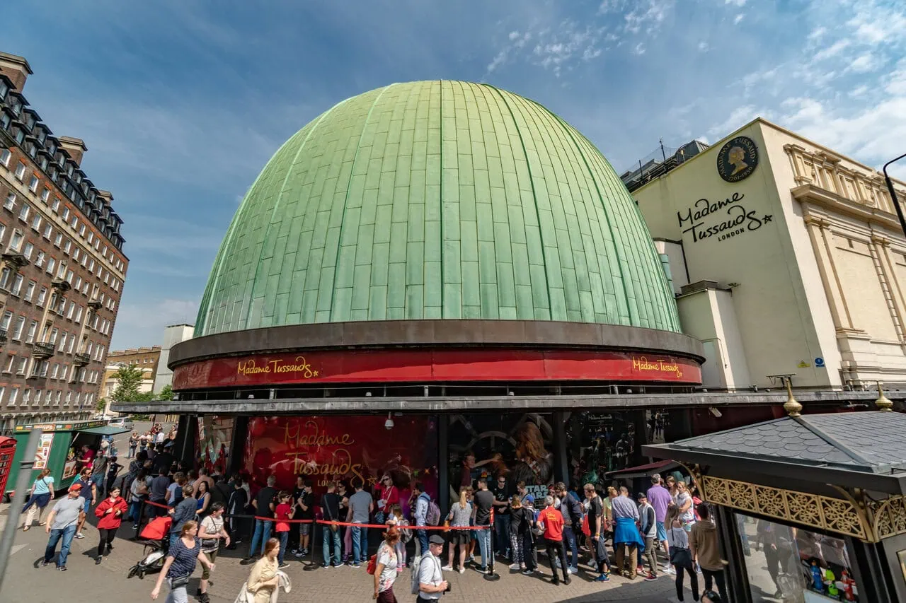 Madame Tussauds London entrance building with green dome and visitors queueing outside