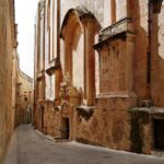 Narrow limestone street in Valletta Malta near St Johnโs Co-Cathedral