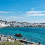 Mykonos Town coastline with white buildings and turquoise sea Greece