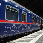 Nightjet sleeper train at station platform in Europe at night