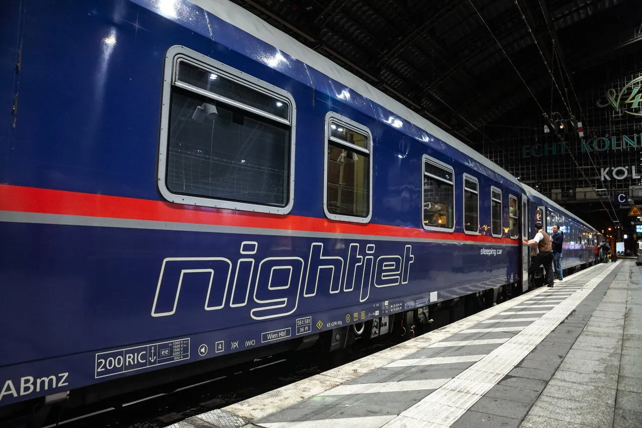 Nightjet sleeper train at station platform in Europe at night