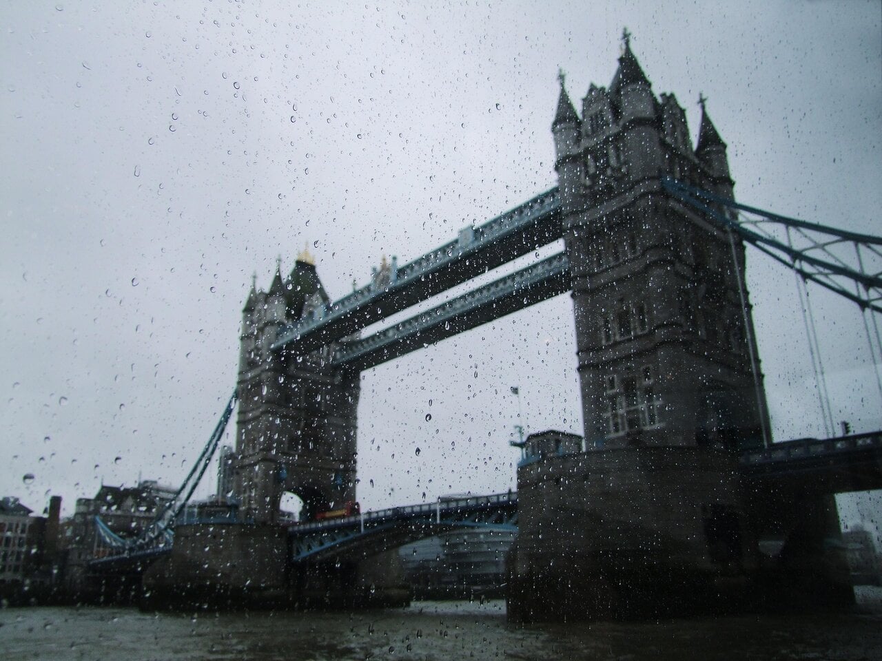 Tower Bridge in London seen through rain drops on a window on a rainy day