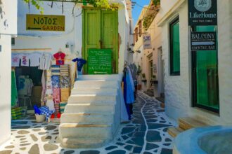 Paros old town street with shops and white buildings Greece