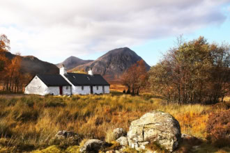 Scottish Highlands cottage and mountains on the North Coast 500 route