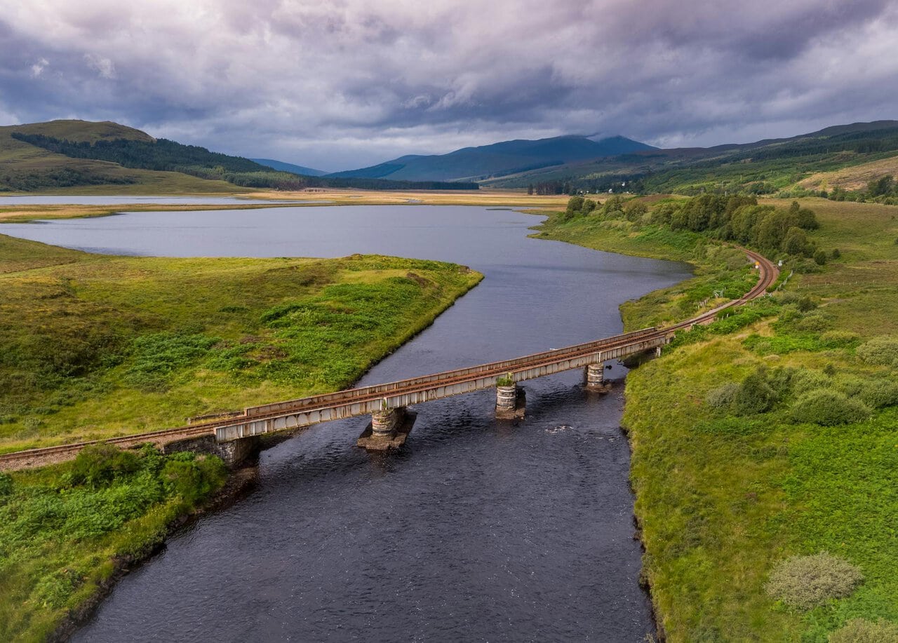 Scenic railway line crossing river in the Scottish Highlands ScotRail route