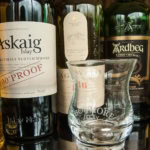 Scottish whisky bottles and tasting glass from Islay distilleries