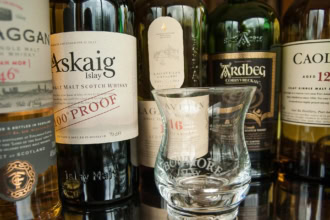 Scottish whisky bottles and tasting glass from Islay distilleries