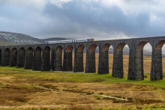 Settle to Carlisle railway train crossing Ribblehead Viaduct Yorkshire Dales