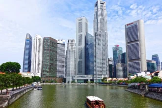 Singapore River cruise boat with city skyline