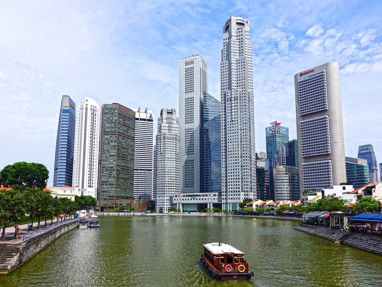 Singapore River cruise boat with city skyline