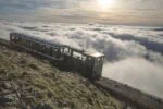 Snowdon Mountain Railway train above clouds on Mount Snowdon in Wales