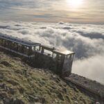 Snowdon Mountain Railway train above clouds on Mount Snowdon in Wales