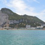 Rock of Gibraltar viewed from the sea with city and coastline
