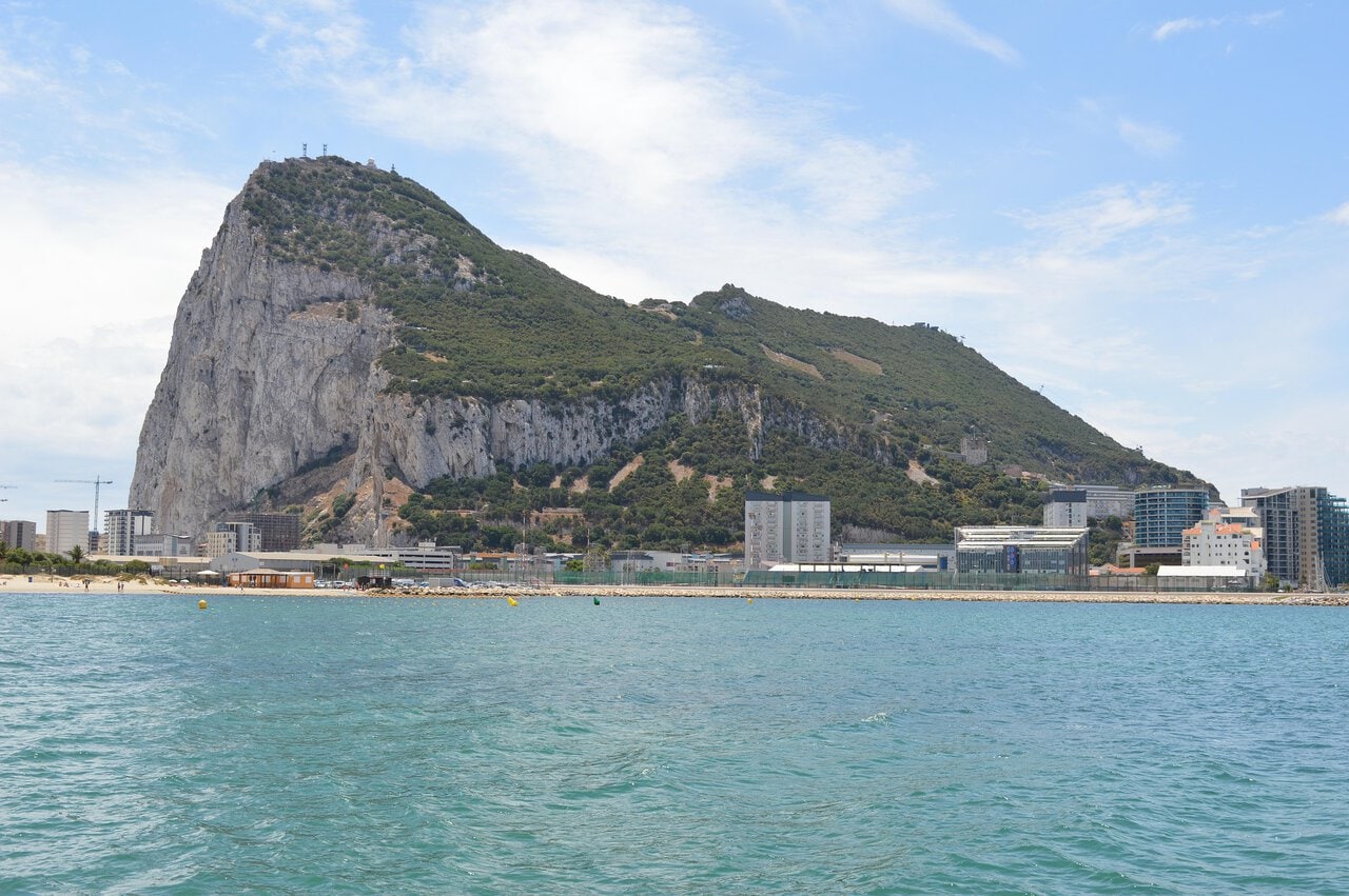 Rock of Gibraltar viewed from the sea with city and coastline