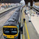 TransPennine Express train at York railway station platform with passengers