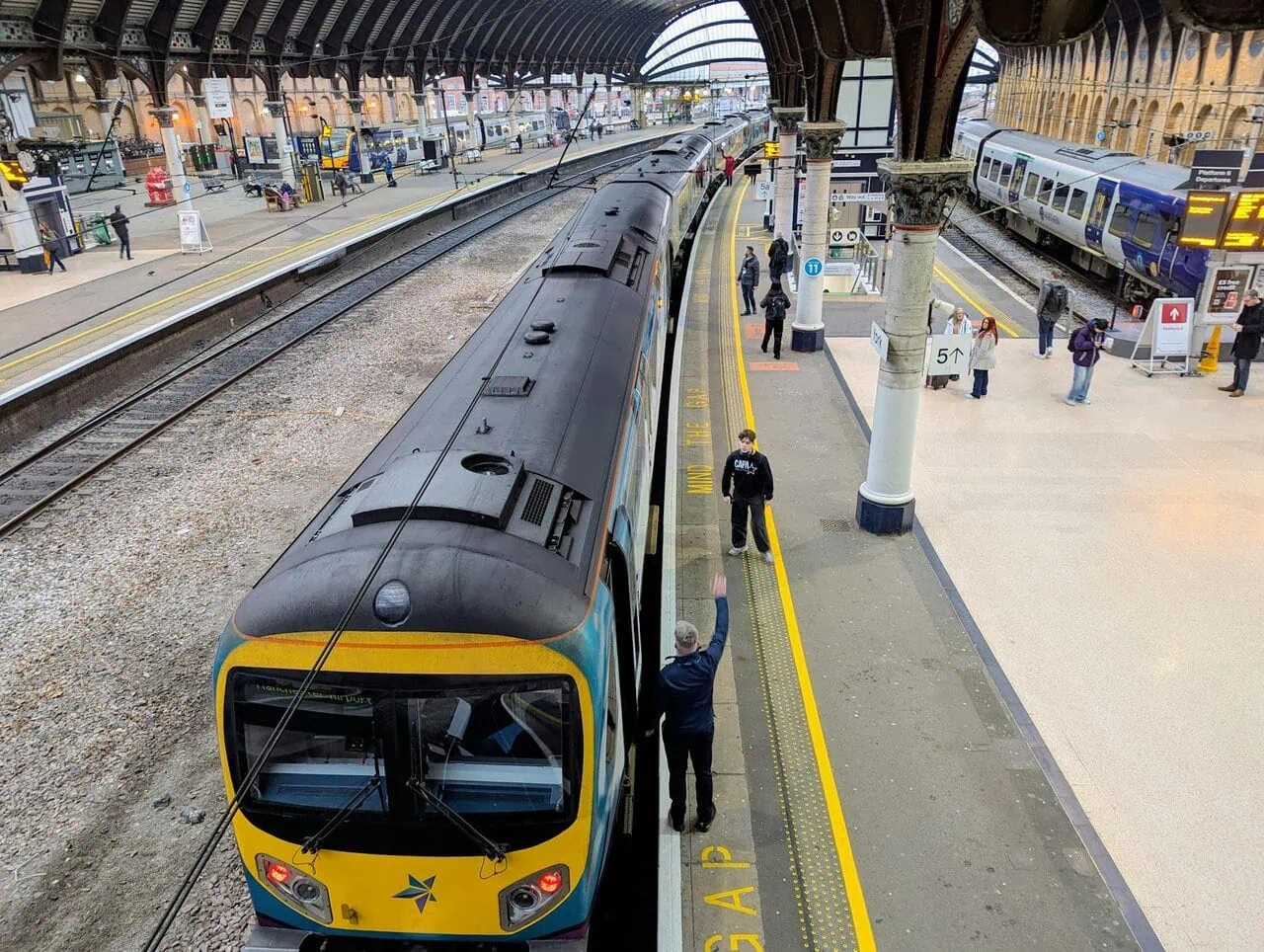 TransPennine Express train at York railway station platform with passengers