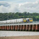 Train crossing Barmouth Bridge on Cambrian Coast Line in Wales
