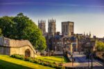 View of York Minster and city walls with bridge and gardens in York