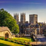 View of York Minster and city walls with bridge and gardens in York