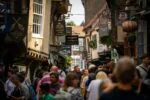 Crowds walking through The Shambles in York during a guided walking tour