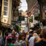 Crowds walking through The Shambles in York during a guided walking tour
