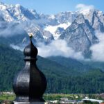 Zugspitze mountain in Germany with alpine village and church in foreground