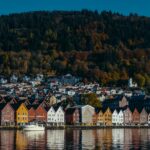 Colourful Bryggen waterfront reflected in Bergen harbour Norway