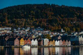 Colourful Bryggen waterfront reflected in Bergen harbour Norway