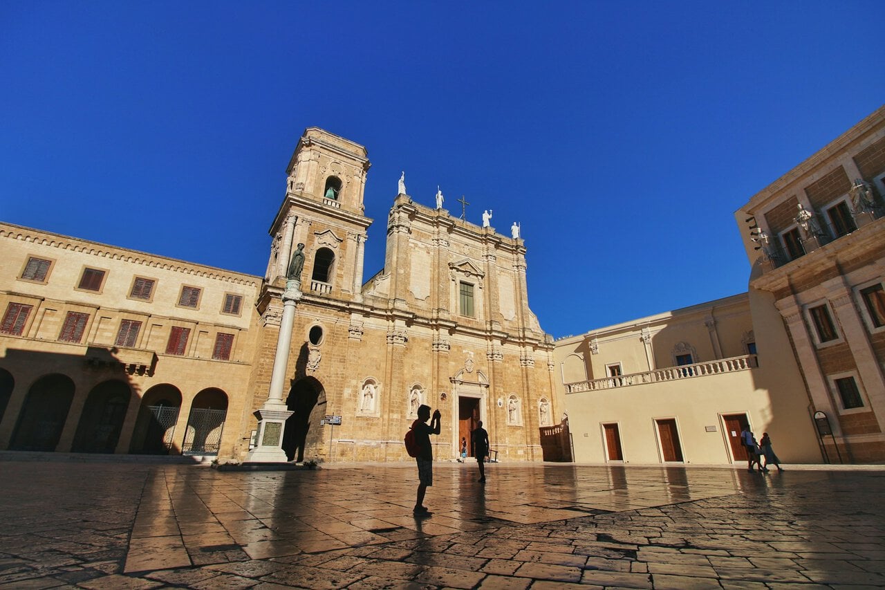 Historic cathedral square in Brindisi in Southern Italy under a clear blue sky