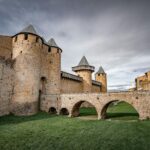 View of the medieval fortress walls and towers of Carcassonne in southern France near the airport transfer route into the historic UNESCO-listed citadel.
