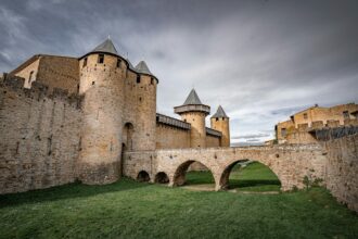 View of the medieval fortress walls and towers of Carcassonne in southern France near the airport transfer route into the historic UNESCO-listed citadel.