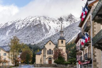 Chamonix town centre with church and Mont Blanc mountains in the background after transfer from Geneva Airport