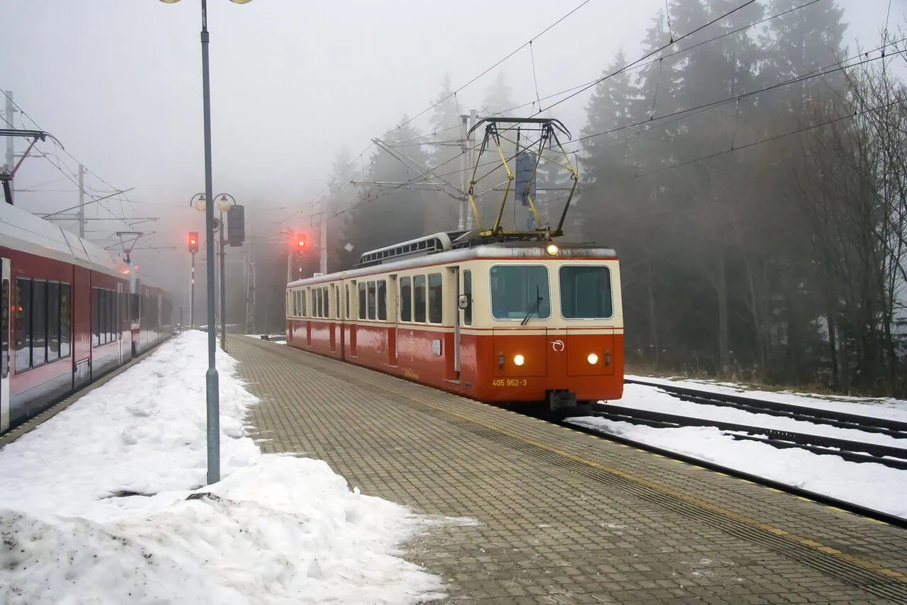 Historic Tatra cog railway train at a snowy mountain station in the High Tatras