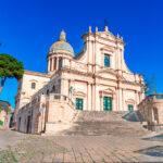 Historic Baroque church in Ragusa near Comiso Airport in southeastern Sicily under a bright blue Mediterranean sky