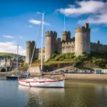 Medieval Conwy Castle overlooking boats on the estuary in North Wales