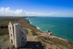 Historic Cornish tin mining ruins and engine house overlooking the Atlantic coast in Cornwall’s UNESCO mining landscape.