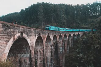Blue train crossing the Nine Arch Bridge near Ella Sri Lanka