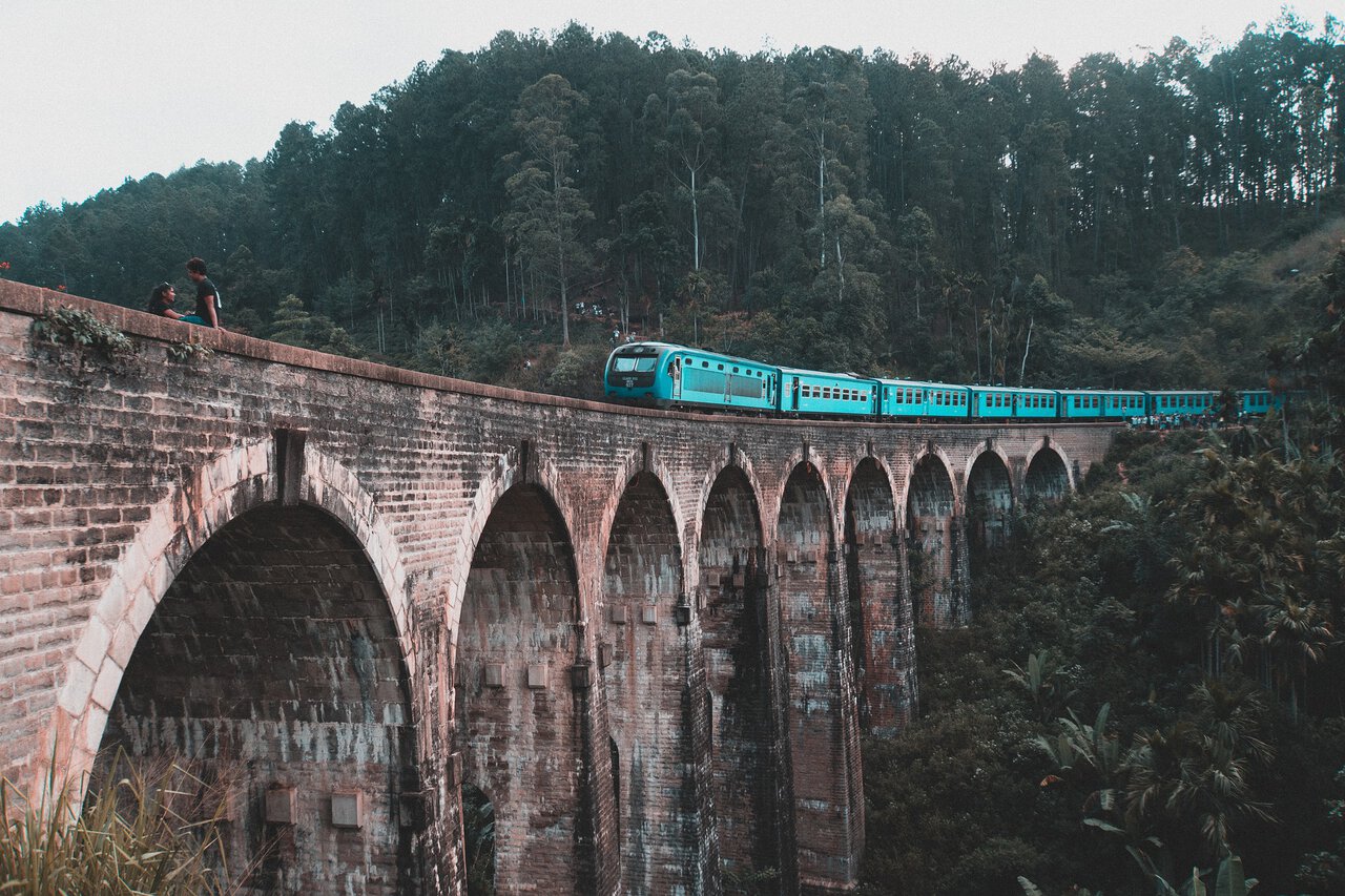 Blue train crossing the Nine Arch Bridge near Ella Sri Lanka