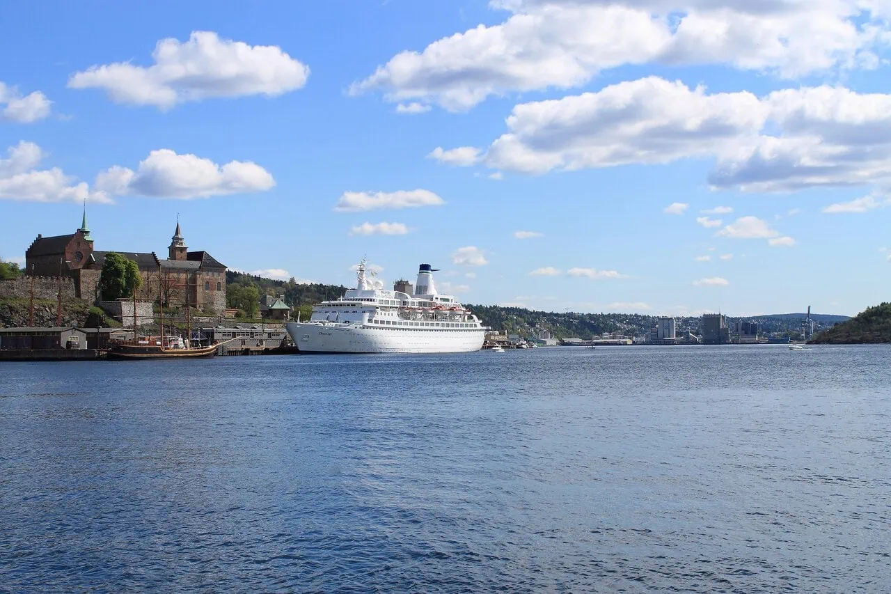 Cruise ship sailing through Oslofjord beside Oslo waterfron