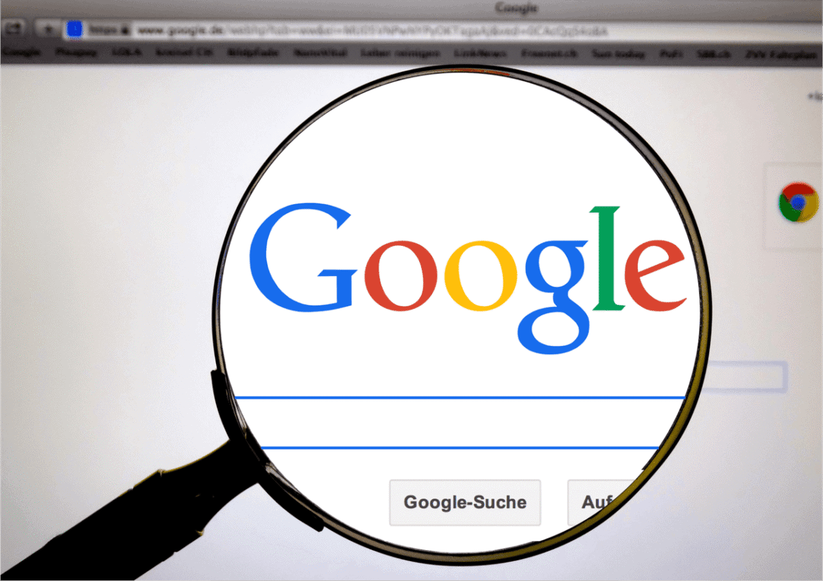 Magnifying glass over Google search page representing Google Flights extreme day trip planning and flight search tools