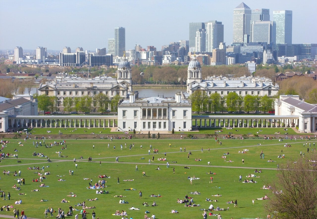 View across Greenwich Park towards the Queen’s House and Canary Wharf skyline in London