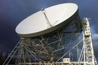 The giant Lovell Telescope at Jodrell Bank Observatory in Cheshire beneath dramatic dark skies