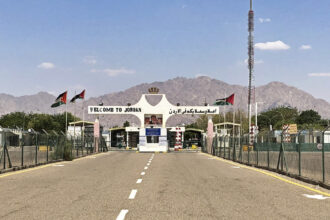 Jordan border crossing near Aqaba with Welcome to Jordan gateway and desert mountains