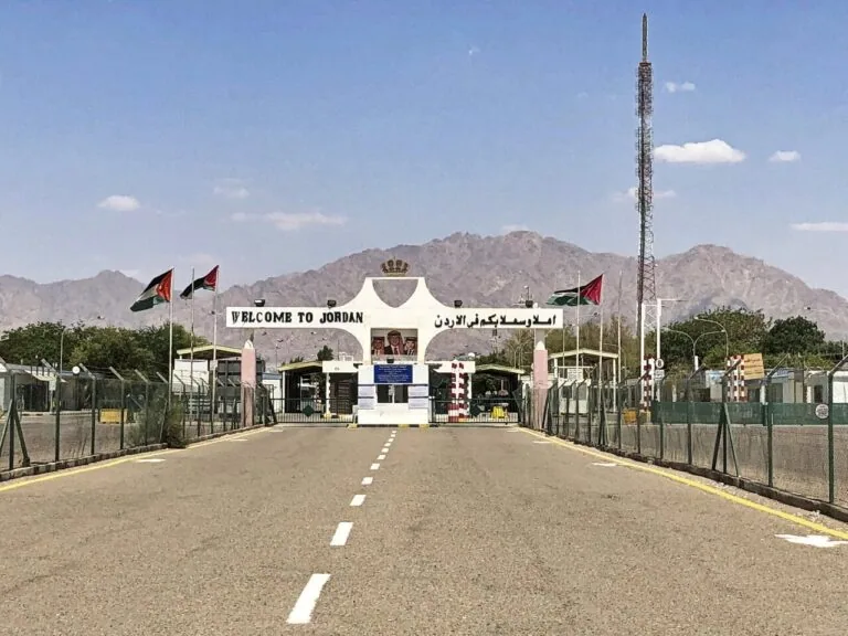 Jordan border crossing near Aqaba with Welcome to Jordan gateway and desert mountains