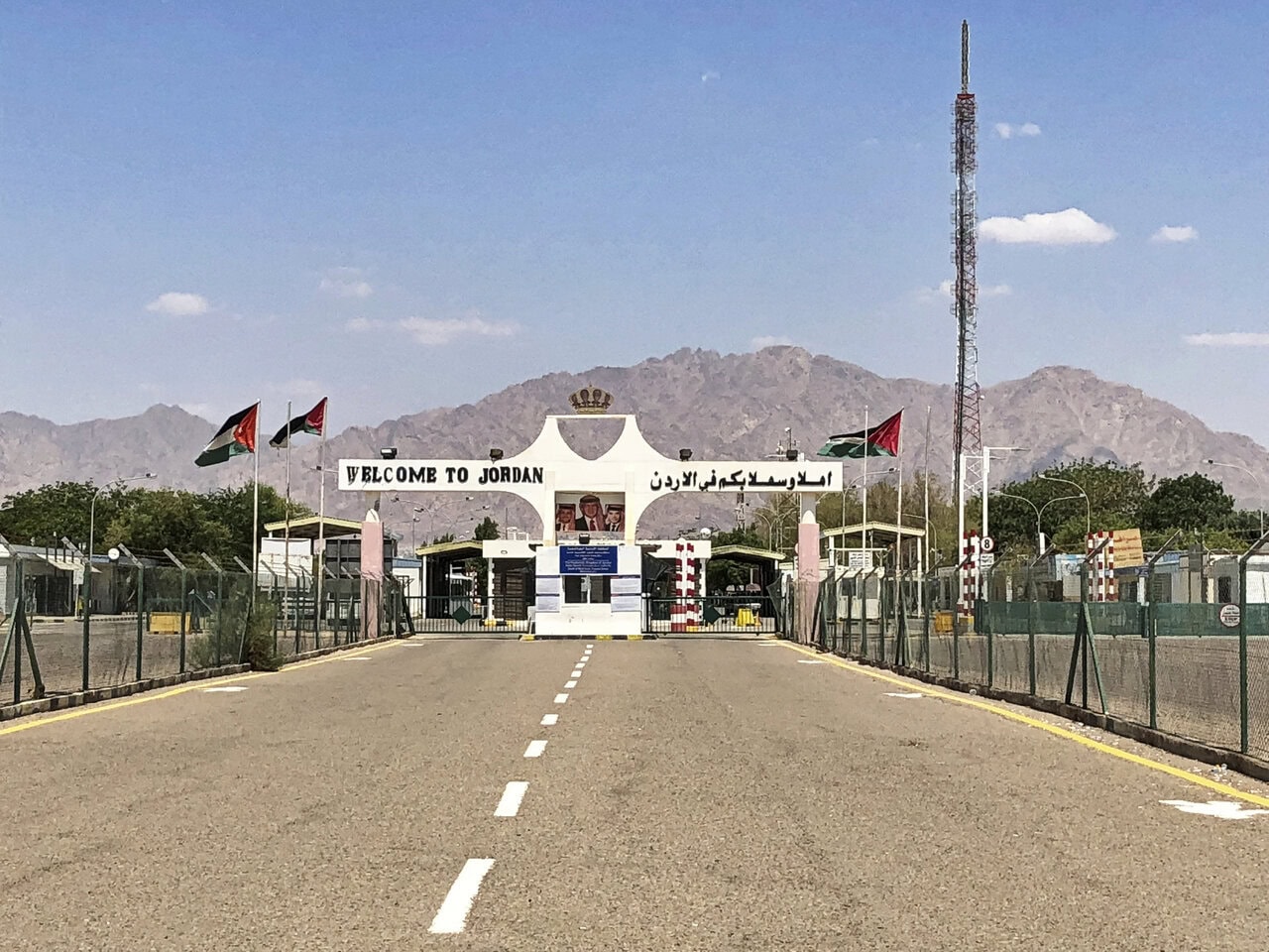 Jordan border crossing near Aqaba with Welcome to Jordan gateway and desert mountains