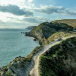 Clifftop walking path overlooking the Jurassic Coast in Dorset with dramatic coastal scenery and sea views