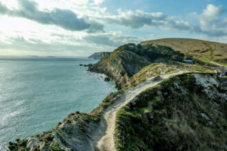 Clifftop walking path overlooking the Jurassic Coast in Dorset with dramatic coastal scenery and sea views